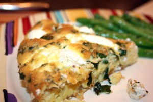 Close up of a piece of the Onion and Goat Cheese Frittata and the Lemon Dijon Green Beans